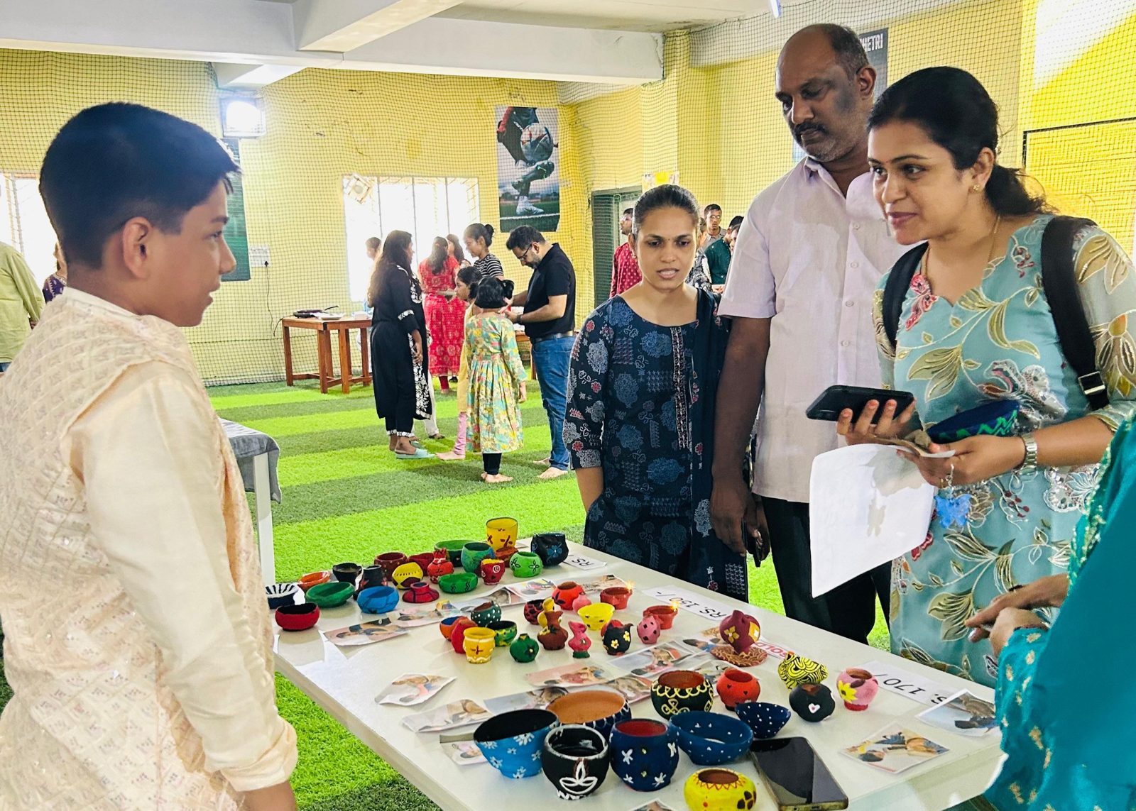 A child sharing their work with parents