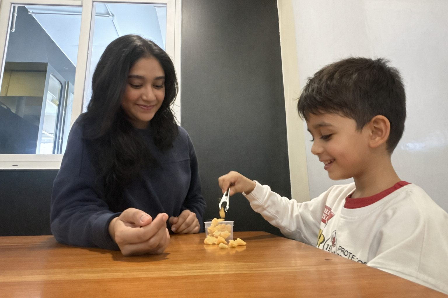A mentor sharing a meal with a child
