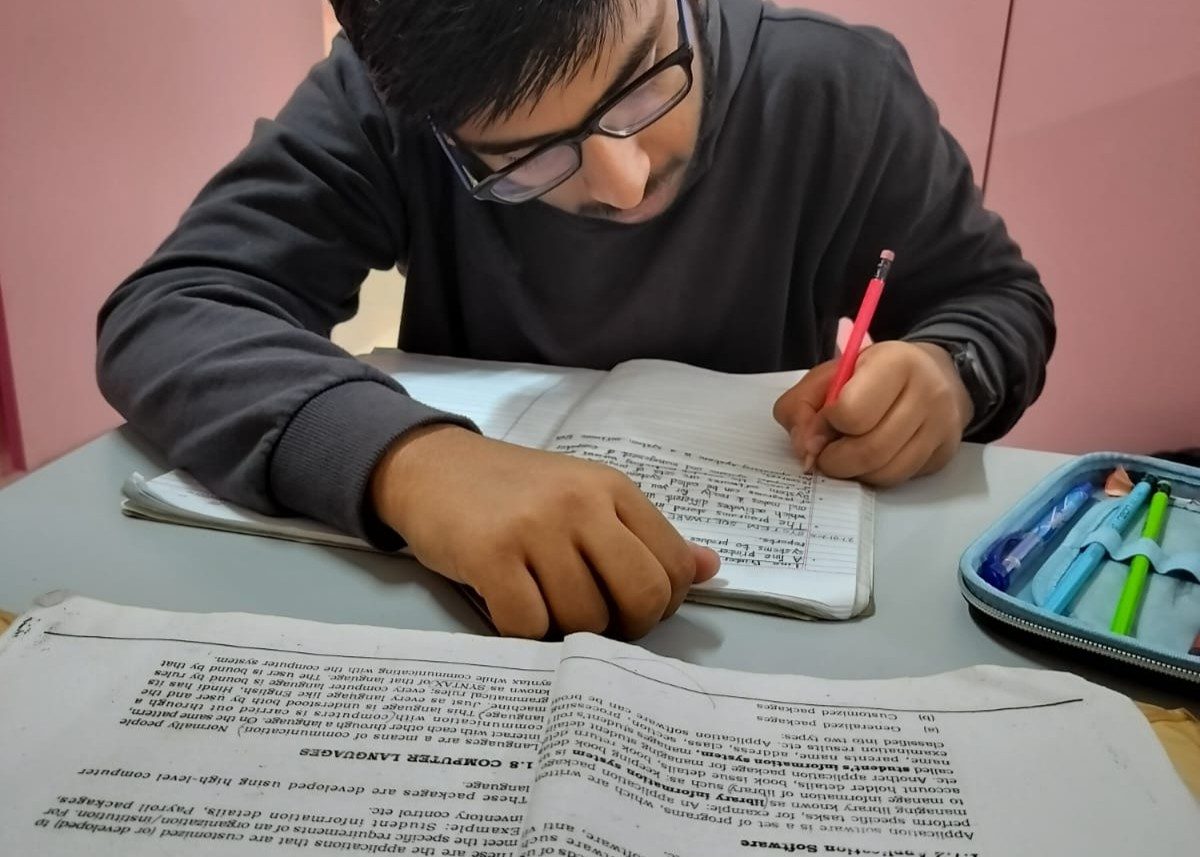 A student studying for NIOS