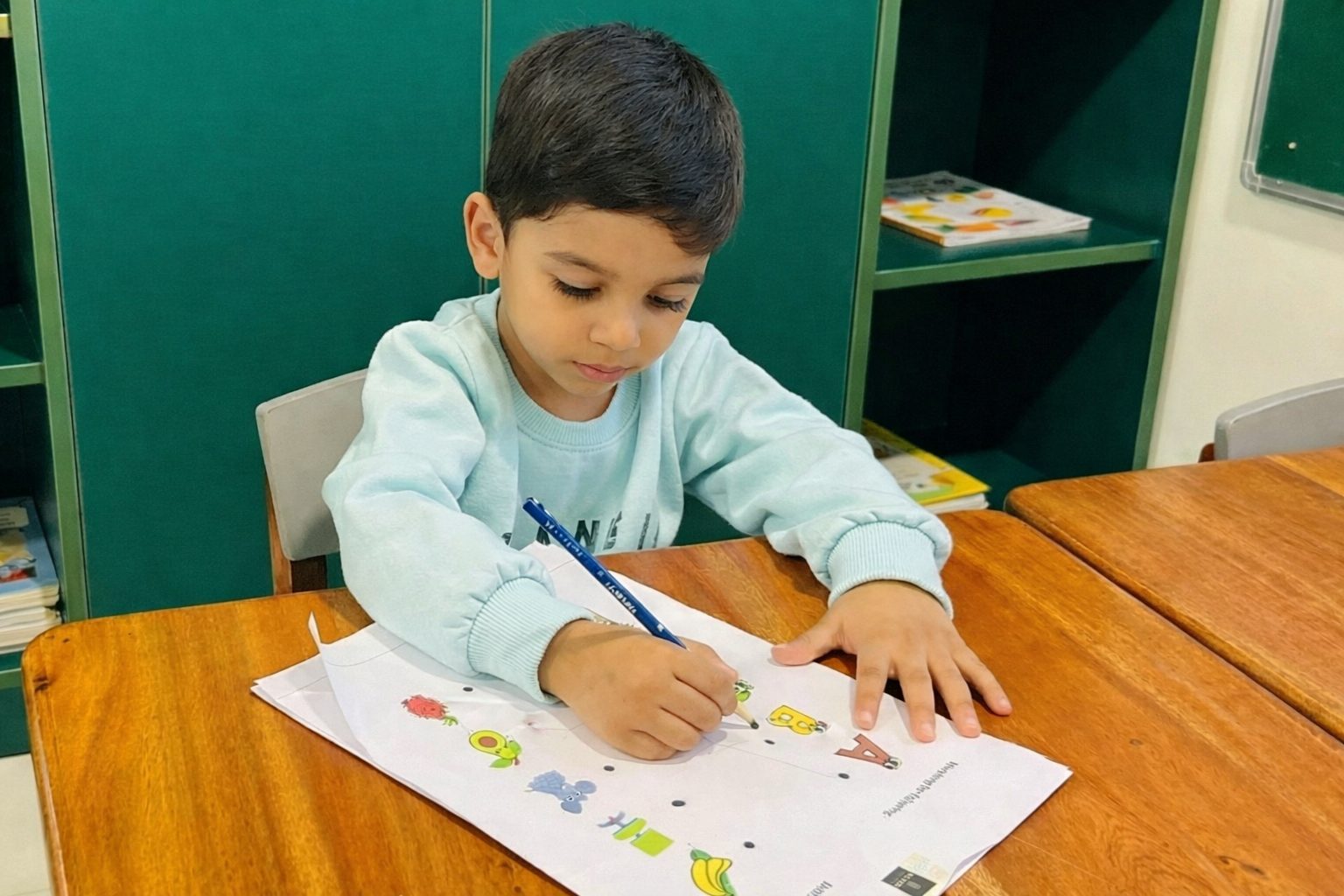 A child colouring a worksheet