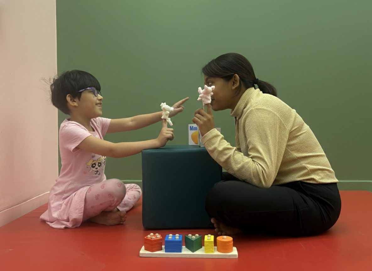 A mentor and a child playing with a sorting toy